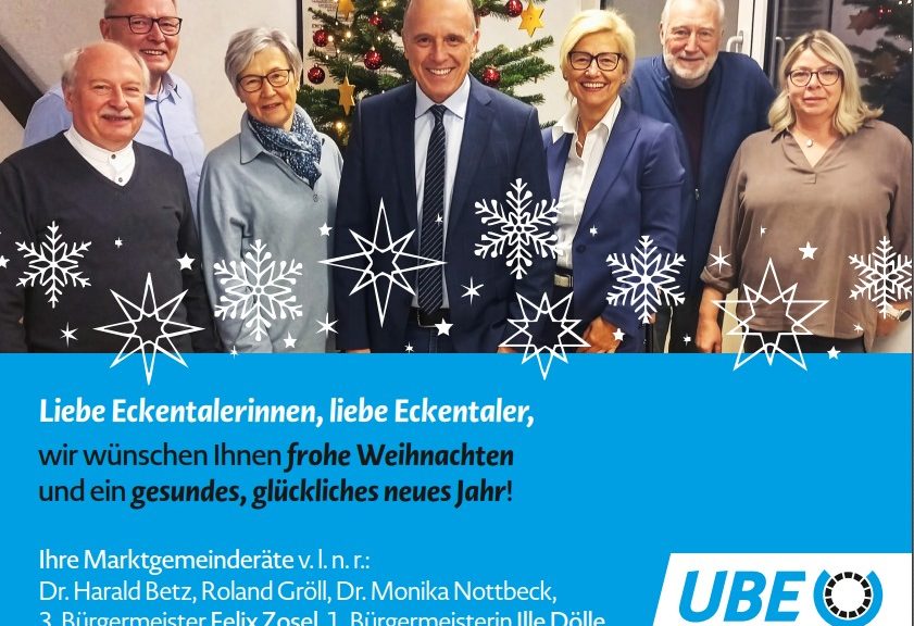 Weihnachts- und Neujahrswünsche der UBE mit ihren Marktgemeinderäten, die vor einem geschmückten Tannenbaum zu sehen sind